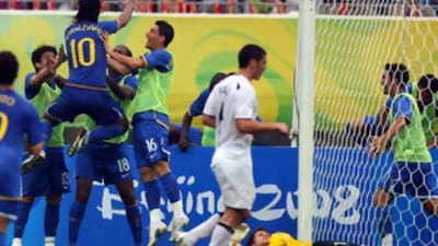 Ronaldinho, centre, celebrates with his teammates after scoring against New Zealand.