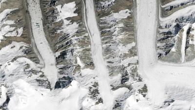 What begins with M? The meandering Mississippi. Mumbai, Miami, and Moscow. These medial moraines merging muck and minerals for millennia! On August 14, 2015, the Operational Land Imager on Landsat 8 captured this image of glaciers in the Tian Shan mountains in northeastern Kyrgyzstan. The trail of brown sediment in the middle of the uppermost glacier is a medial moraine, a term glaciologists use to describe sediment that accumulates in the middle of merging glaciers. Courtesy NASA