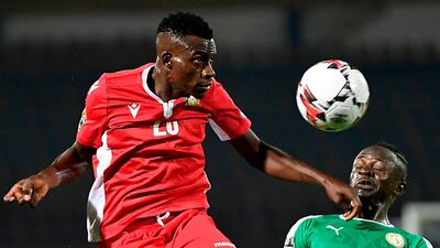 Kenya midfielder Philemon Otieno, heads the ball next to Senegal forward Sadio Mane. Otieno was sent off in the second half for receiving a second yellow card. AFP