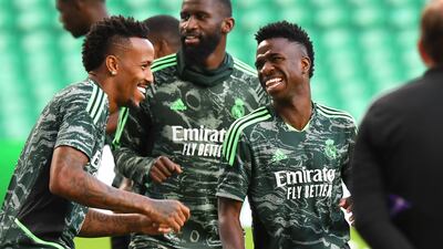 Real Madrid's Brazilian defender Eder Militao (L) and Real Madrid's Brazilian forward Vinicius Junior (R) laugh at they attend a team training session at Celtic Park in Glasgow on September 5, 2022, on the eve of their UEFA Champions League Group F football match against Celtic. (Photo by ANDY BUCHANAN / AFP)