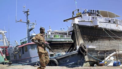 A Somali soldier on patrol in Bosaso harbour in Somalia. A car bombing in the city was aimed at advancing Qatar's interests in the country against the UAE. AFP