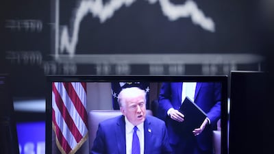 US President Donald Trump is seen on a TV screen at the stock exchange in Frankfurt, Germany, on Thursday. AFP