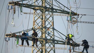 Workers prepare an electricity transmission tower, also called an electricity pylon, in order to hang electricity transmission cables from it on December 4, 2014 near Luebben, Germany. Germany is expanding its electricity grid as part of its large-scale shift from conventional coal, gas and nuclear-based energy production to renewable sources, especially wind and solar. Sean Gallup / Getty Images
