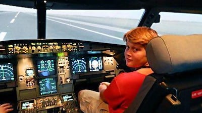 Joe Thompson, 11, at the controls of an Etihad Airways Airbus A320 flight simulator. The Al Ain schoolboy is stranded in the UAE after developing a chronic fear of flying. He was due to return to the UK over the summer.