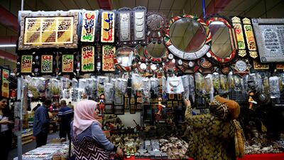 Iraqi women look at the Egypt section of the Baghdad International Fair, Iraq. Reuters