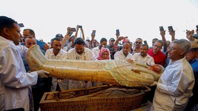Archaeologists remove the cover of an ancient painted coffin discovered at Al-Asasif Necropolis in the Vally of Kings in Luxor, Egypt. Reuters