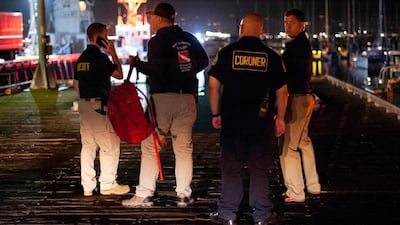 Local law enforcement and coroners work to retrieve the bodies found by diving teams. AP