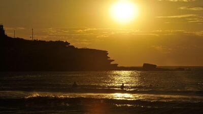 epa05725519 People go for an early morning surf at sunrise at Bondi Beach in Sydney, Australia. Joel Carrett / EPA