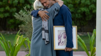 Tarulata Shukla embraces her son after showing the photographs to Sheikh Mohamed