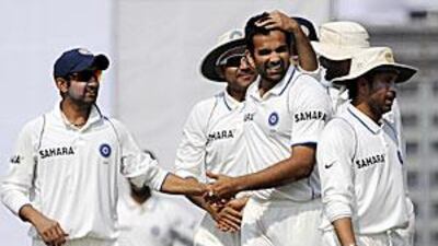 Indian cricketers congratulate Zaheer Khan, second from night, after his first seven-wicket haul in an innings.