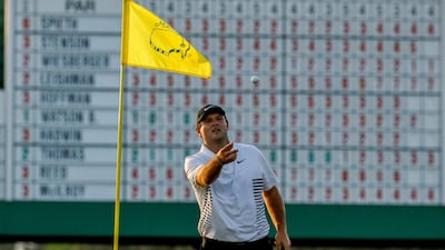 Patrick Reed catches a ball in the 17th green during the second round at the US Masters. Charlie Riedel / AP Photo