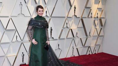 Olivia Colman in forest green Prada. Photo: AFP
