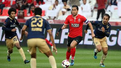Luis Jimenez, centre, is surrounded by Dubai players during last night’s encounter. The Chilean scored twice in the 4-2 win. Pawan Singh / The National