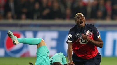Victor Osimhen of Lille is tackled by Kepa Arrizabalaga of Chelsea. Getty Images