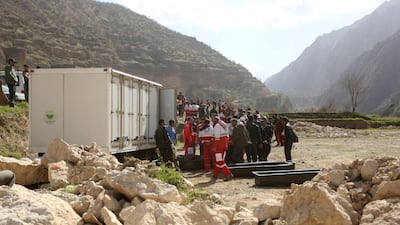 People gather near the site of a private plane crash, Iran. Tasnim News Agency / Reuters
