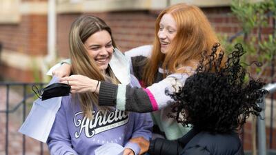 Emelia Ambrose is hugged by her friend Mali Jones after opening her results at Ffynone House School, Swansea, Wales.