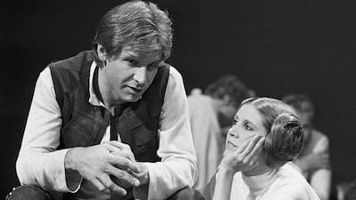 In this November 13, 1978 file photo, Harrison Ford talks with Carrie Fisher during a break in the filming of the CBS-TV special The Star Wars Holiday in Los Angeles. George Brich / AP photo