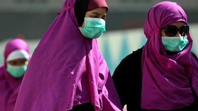 Muslim pilgrims in the holy city of Mecca, Saudi Arabia, wear surgical masks to avoid being infected with Mers. A World Health Organisation report on Friday praised the UAE's efforts in tackling the virus. AP