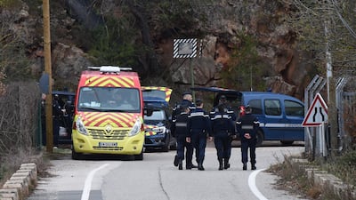 French gendarmes and firefighters walk at the site of the accident. Anne-Christine Poujoulat / AFP