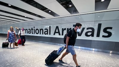 Passengers arrive at Heathrow Airport, London, December 5, 2021.