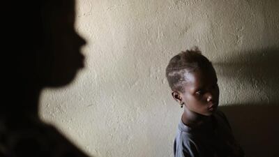 Miamu Saryon, 7, stands in the hallway of Mawah clinic, in downtown Monrovia, Liberia. Jerome Delay / AP