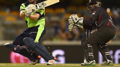 UAE wicketkeeper Swapnil Patil, right, looks as Ireland batsman Gary Wilson plays a shot during the World Cup in Brisbane on Wednesday. Indranil Mukherjee / AFP