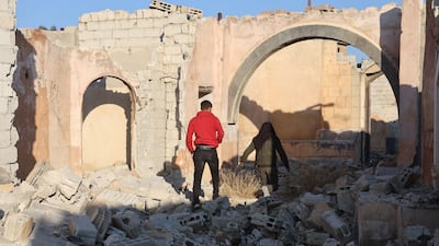 People walk among the rubble of damaged buildings in Shamiya village in Damascus. The village was built as a set for the production of a popular Syrian television series featuring houses, cafes, theatres, and museums. All Photos: EPA