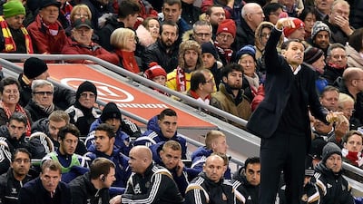 Sunderland manager Gus Poyet, right, gestures as Liverpool manager Brendan Rodgers, left, watches during their English Premier League match at Anfield in Liverpool, north west England, on December 6, 2014. The teams played to a scoreless draw. Paul Ellis / AFP