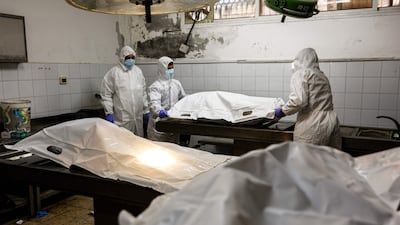 Forensic experts examine the bodies of Gazans in Al Shifa Hospital, Gaza city, earlier this month. AFP
