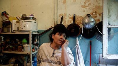 Emine Kilic, a Turkish squatter and mother of 10, speaks on the phone inside a kitchen.