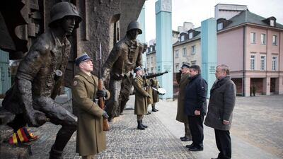 The German minister for economic affairs, Sigmar Gabriel, second right, and Rolf Nikel, German ambassador in Poland, right, visit the Warsaw Uprising Monument. Bernd bon Jutrczenka / EPA