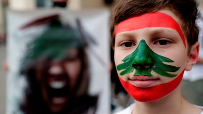 A Lebanese boy with a national flag painted on his face takes part in an anti-government demonstration in the capital Beirut's downtown district. AFP