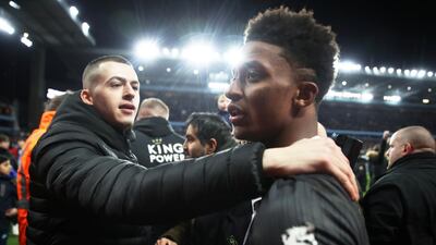 Leicester City's Demarai Gray is consoled by a supporter at the end of the match. Reuters