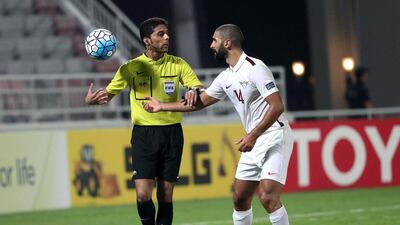El Jaish’s Ali Sanad (R) talks with referee Fahad Al Mirdasi. Karim Jaafar / AFP