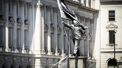 Banksy's sculpture of a man in a suit, face obscured by a flag, was unveiled in London on April 29, 2026. Getty Images