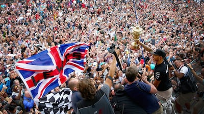 Mercedes-GP driver Lewis Hamilton, right, in black shirt, celebrates with his countrymen after winning the British Grand Prix at Silverstone on Sunday. Clive Mason / Getty Images