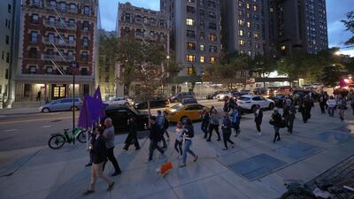 People march during a prayer vigil for victims of the coronavirus pandemic in New York City. The Cathedral of St John the Divine and Mourning Into Unity hosted a candlelight prayer vigil and march to honour the lives of people who have been affected by the pandemic. Getty Images