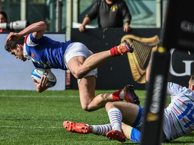France wing Damian Penaud, left, scores a try against Italy during the Six Nations match in Rome. AFP