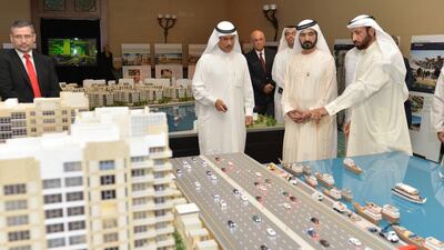Sheikh Mohammed (second right) looks at the Investment Corporation of Dubai projects. Wam