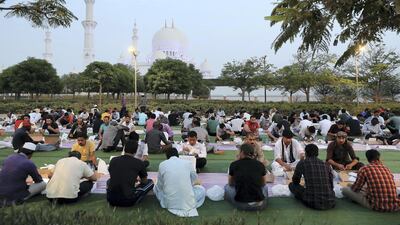 People break their fast on the first day of Ramadan at the Sheikh Zayed Grand Mosque in Abu Dhabi. Pawan Singh / The National
