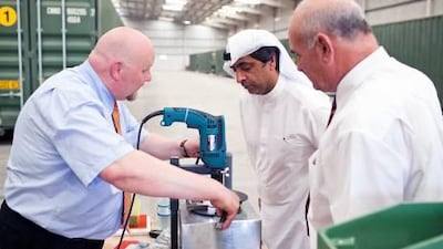 Sioplast executives Siegfried Kreft, left, and Heiko Schroter, right, display the new green product’s qualities to Ahmed Ibrahim, the chief executive officer of Hydra, centre.