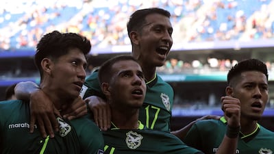 Bolivia's Miguel Terceros, left, celebrates with teammates Robson Matheus, second left, Roberto Fernandez and Ramiro Vaca after scoring a penalty during the World Cup qualifiers semi-final against Suriname in Mexico. AFP