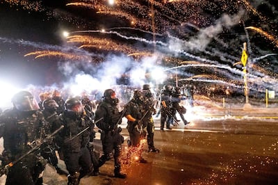 Police use chemical irritants and crowd control munitions to disperse protesters in Portland, Oregon. AP Photo
