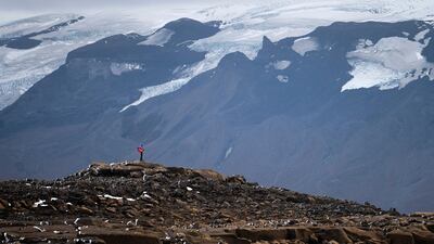 A man stops on his way to the top of what once was the Okjokull glacier, in Iceland. AP