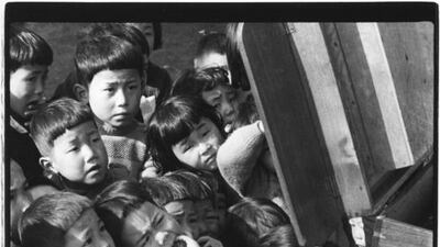Children looking at a picture-card show. Tokyo, 1953. Courtesy Ken Domon / Open Eye Gallery