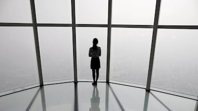 A woman looks at a view of Seoul shrouded by fine dust during a polluted day in Seoul, South Korea. Reuters