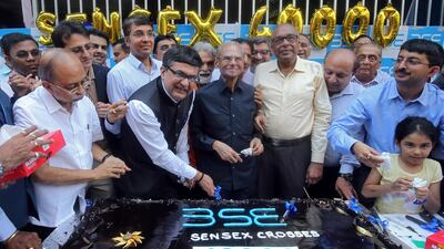Bombay Stock Exchange head Ashishkumar Chauhan cuts a cake to celebrate the Sensex index rising to over 40,000 earlier this year. Reuters