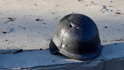 A soldier's helmet with a bullet hole on a street in the Ukrainian capital. AP