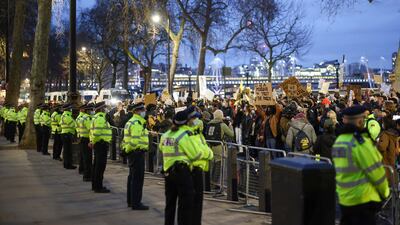 Police officers stand guard outside New Scotland Yard. Reuters