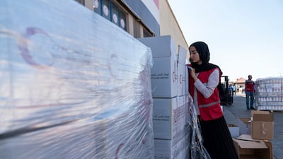 Members of the Egyptian Red Crescent prepare humanitarian aid at a warehouse in Al Arish, near the Rafah crossing with Gaza. Aid access through conflict zones has become an increasing challenge for relief agencies worldwide. Getty Images